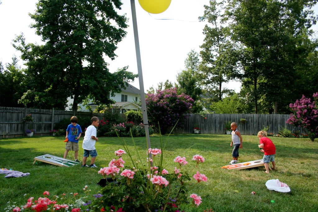 cousins playing cornhole